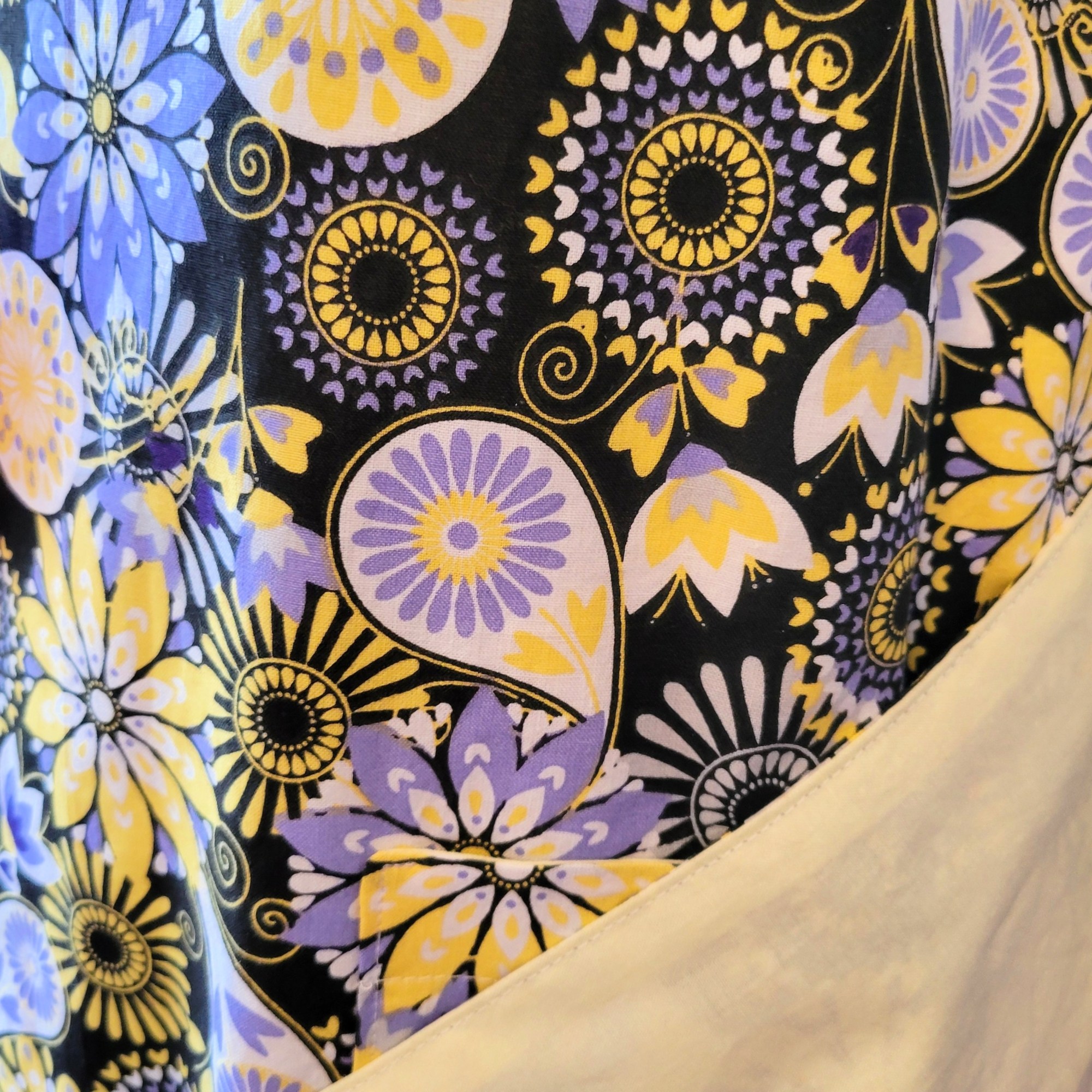 black, yellow, periwinkle and white floral fabric with pale yellow lining