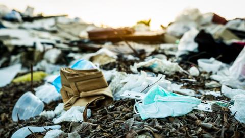 image of disposable medical masks in textile landfill