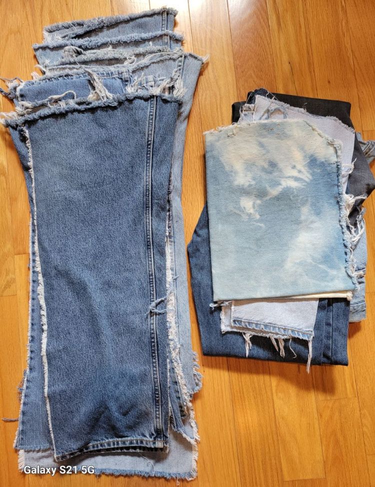 photo of pile of deconstructed denim jeans on hardwood oak floor