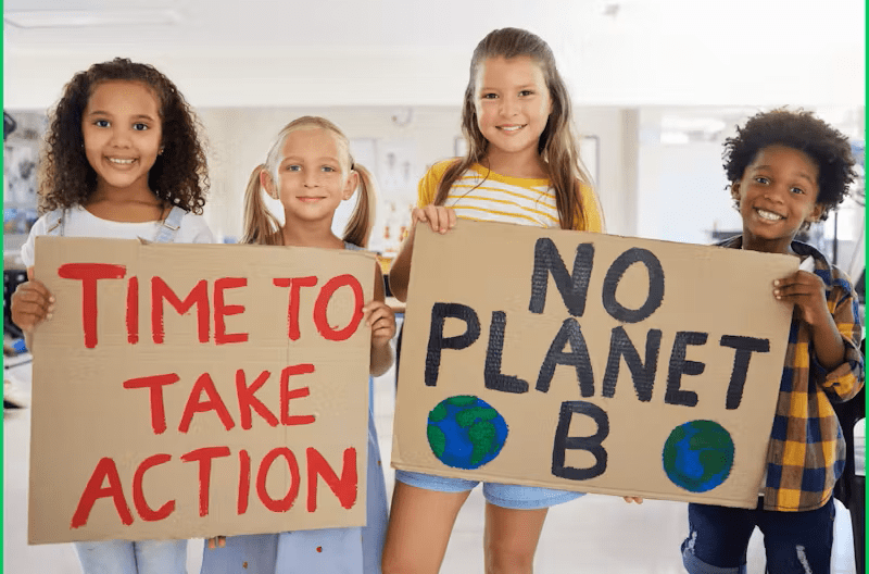 photo of 4 children holding 2 cardboard signs with "Time To Take Action" and "No Planet B"
