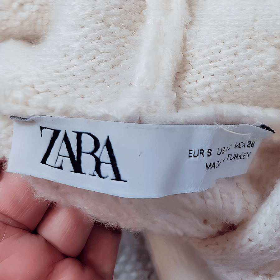 image of white Zara clothing label, a notorious fast fashion clothing brand known for using 100% synthetic, non-biodegradable fibers
