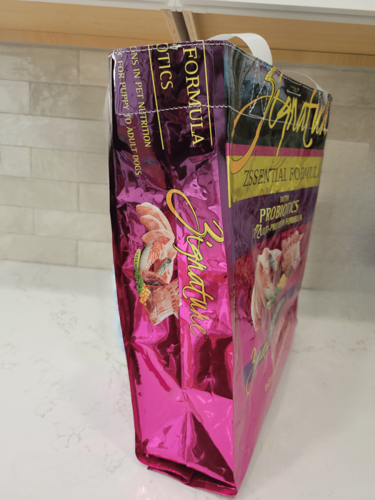 side view of Zignature dog food in bright pink color bag