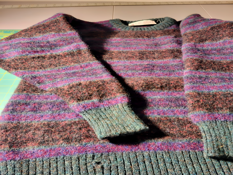 image of a discarded 100% men's sweater felted to be repurposed into women and mens slippers